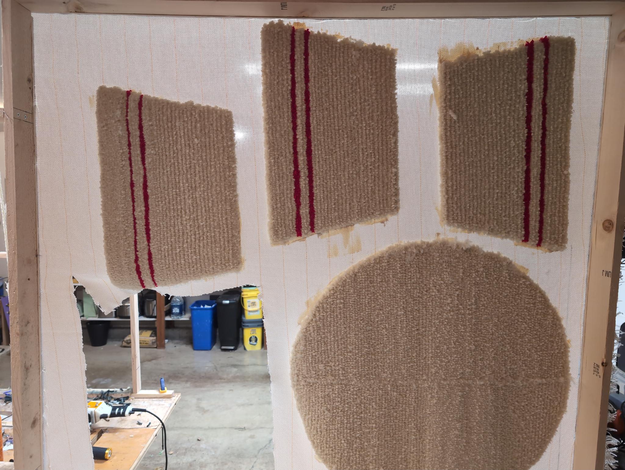 The bowl's cream exterior panels, each with the double red rim stripe, tufted and mounted on the frame alongside the round base panel
